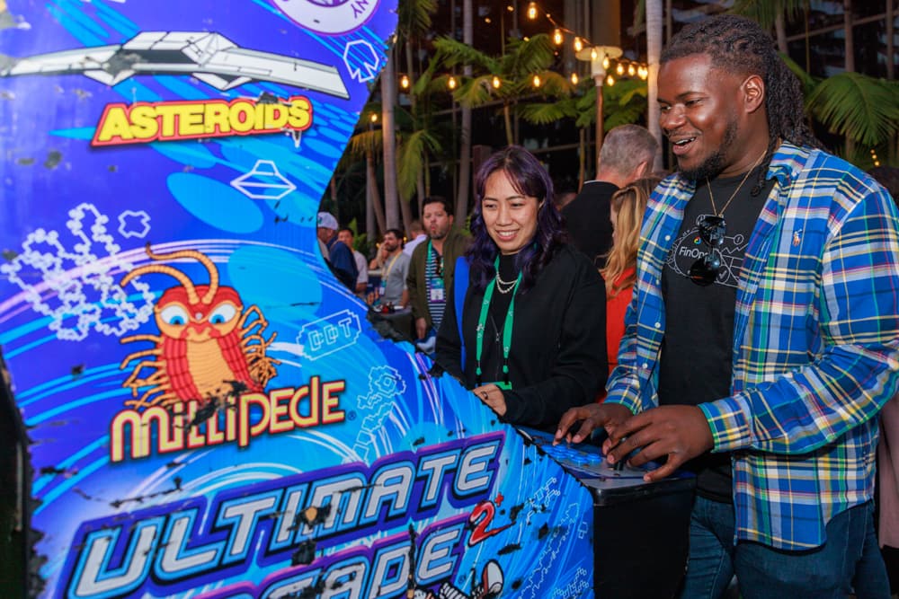 Image from last year's 8Bit after party showing attendees playing games and connecting