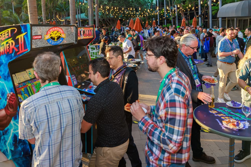 Image from last year's 8Bit after party showing attendees playing games and connecting