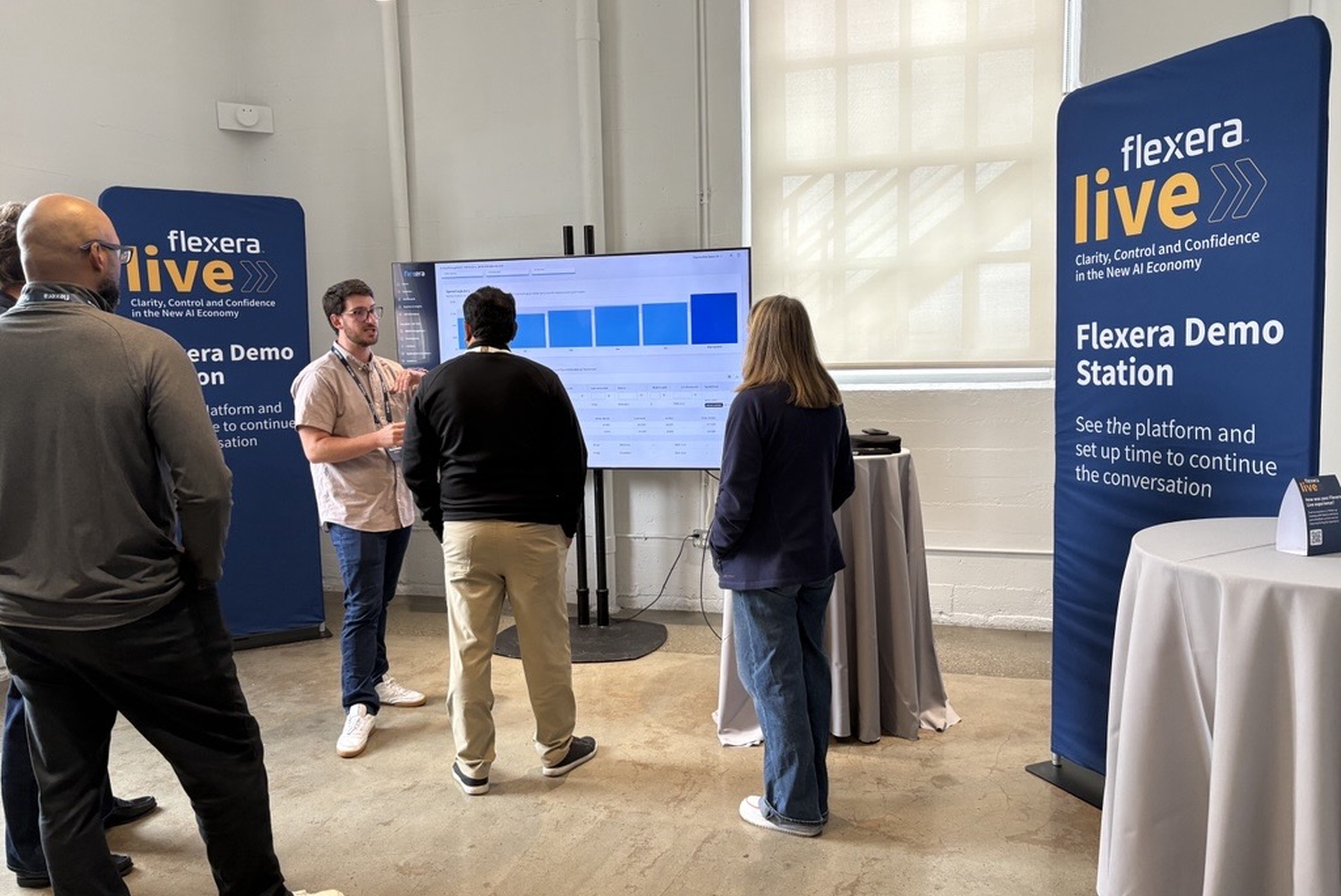 Flexera Live attendees at a demo station