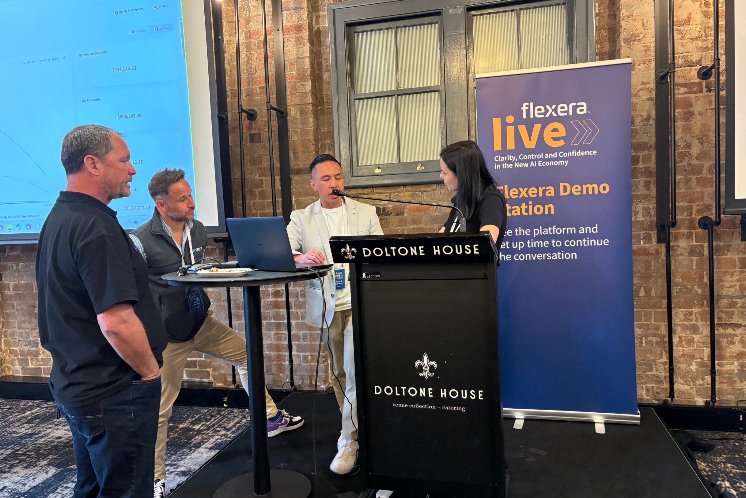 Flexera Live attendees at a demo station